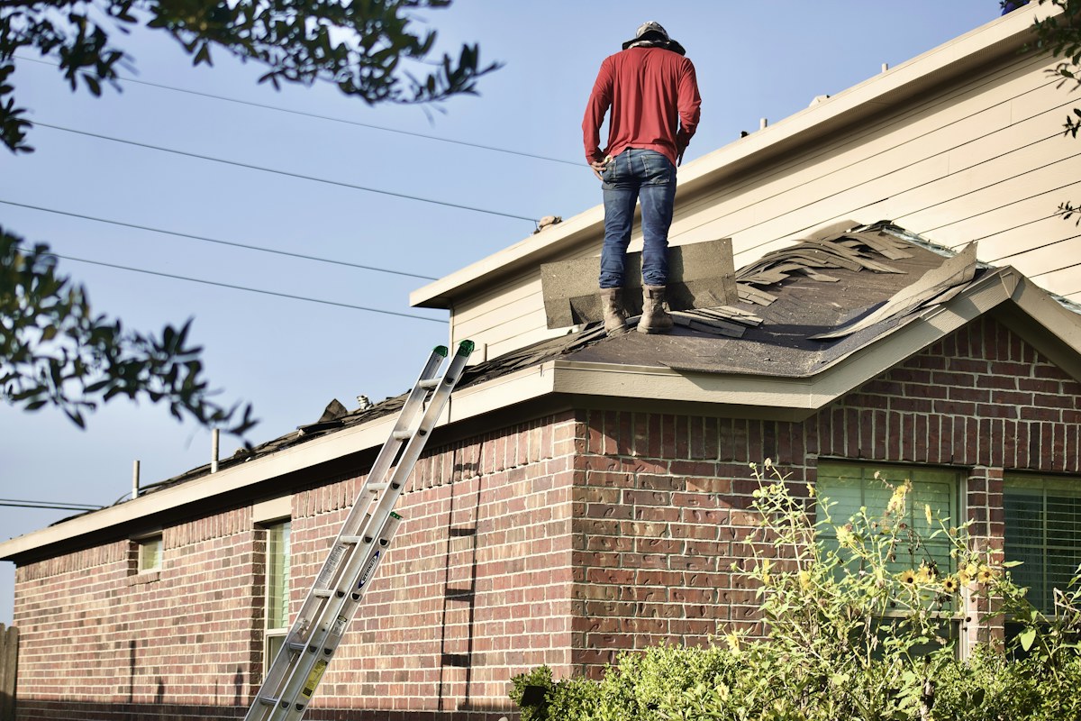 Worker carrying out roofing work on a residential property