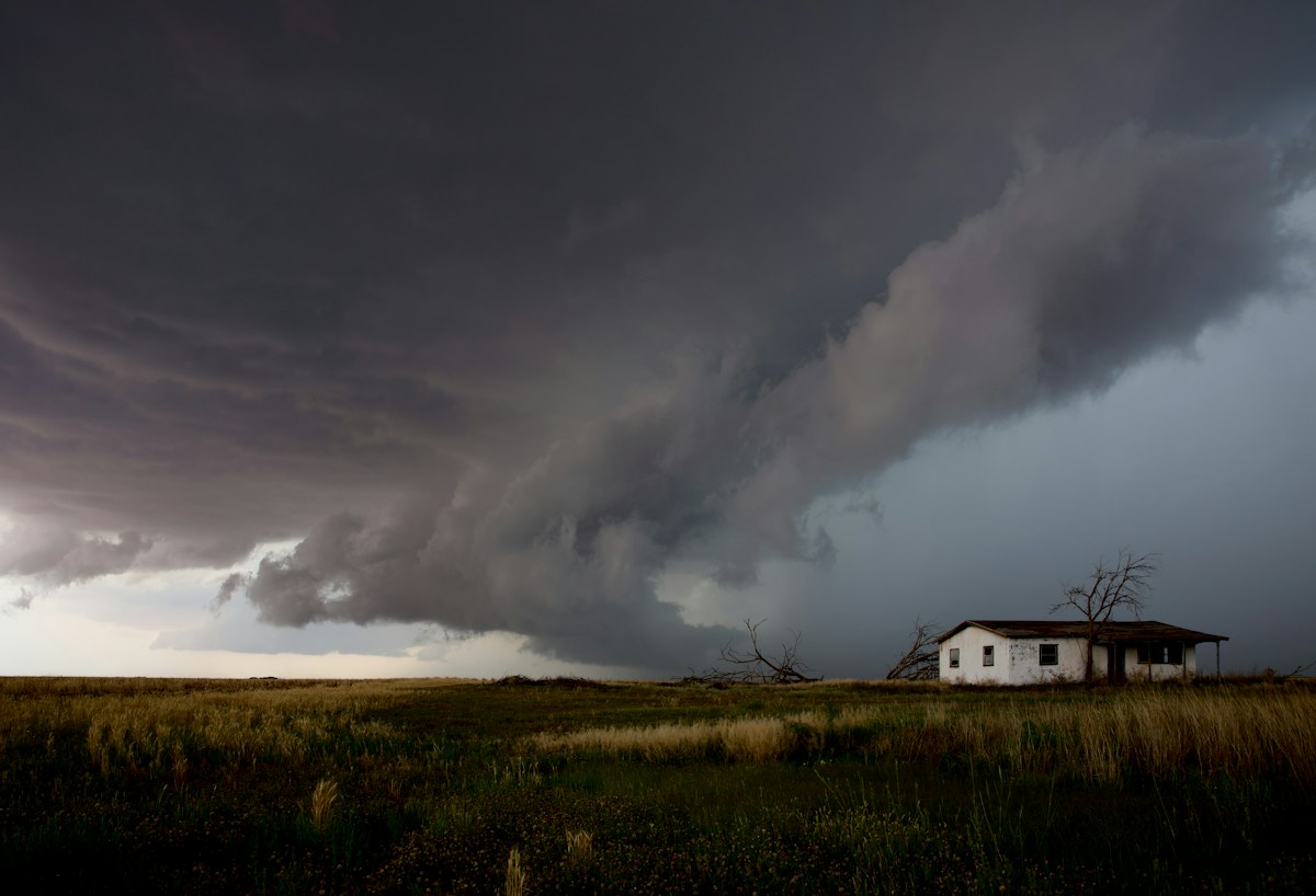 Dark storm clouds gathering over an open landscape